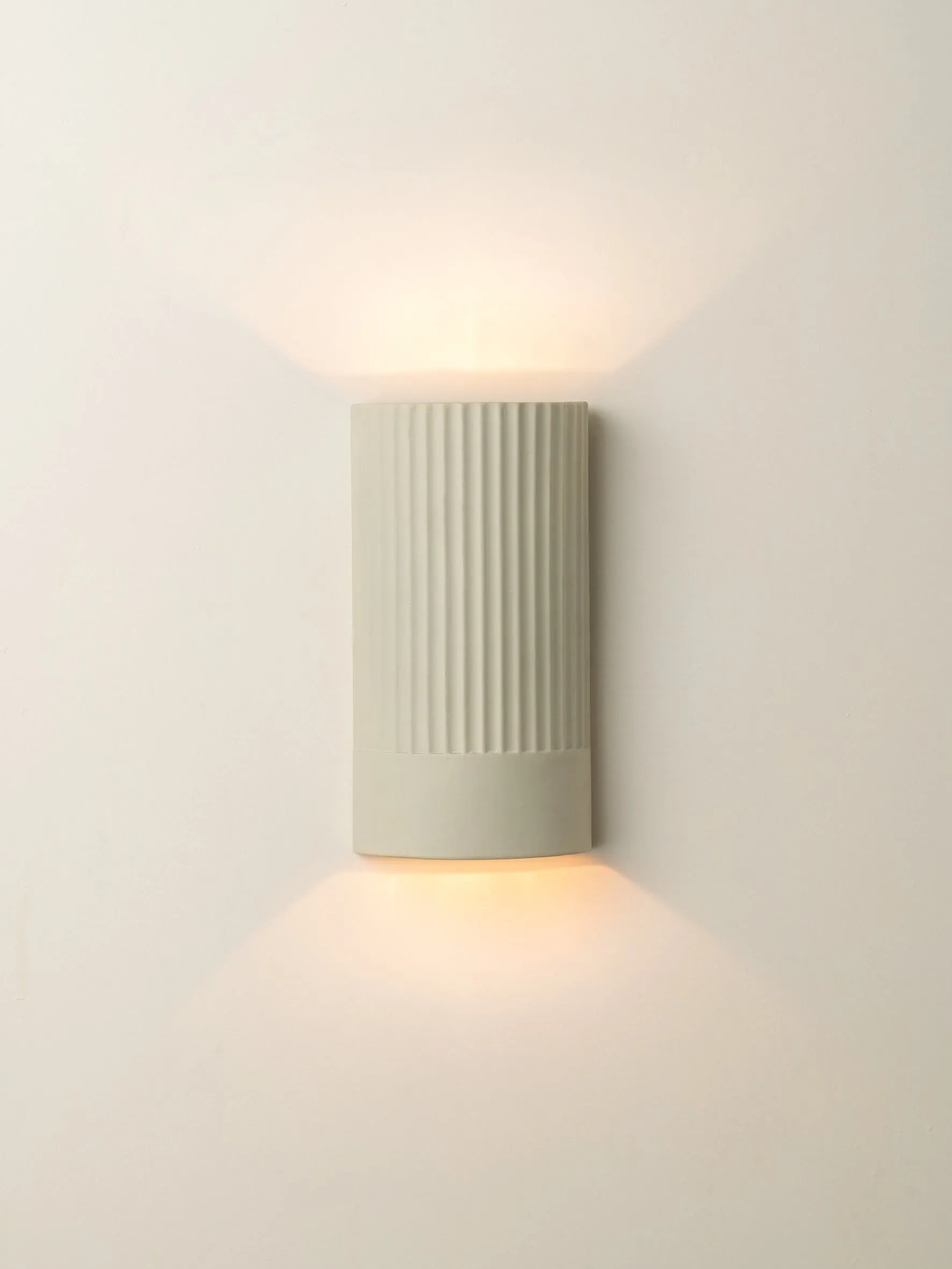 Enza - warm white  ribbed concrete wall light