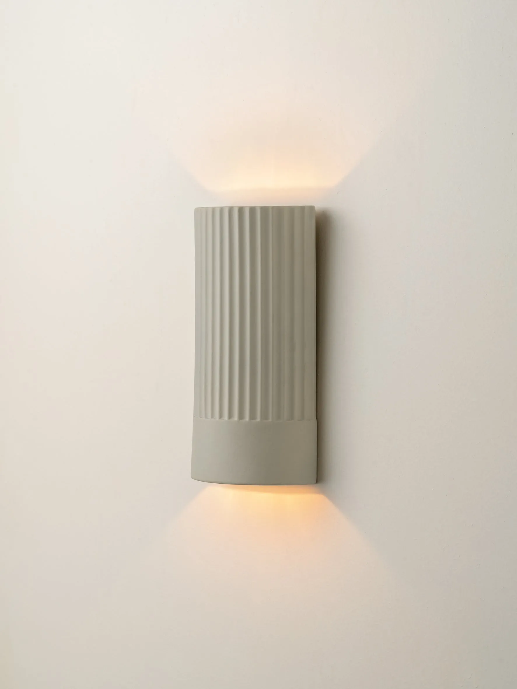 Enza - warm white  ribbed concrete wall light